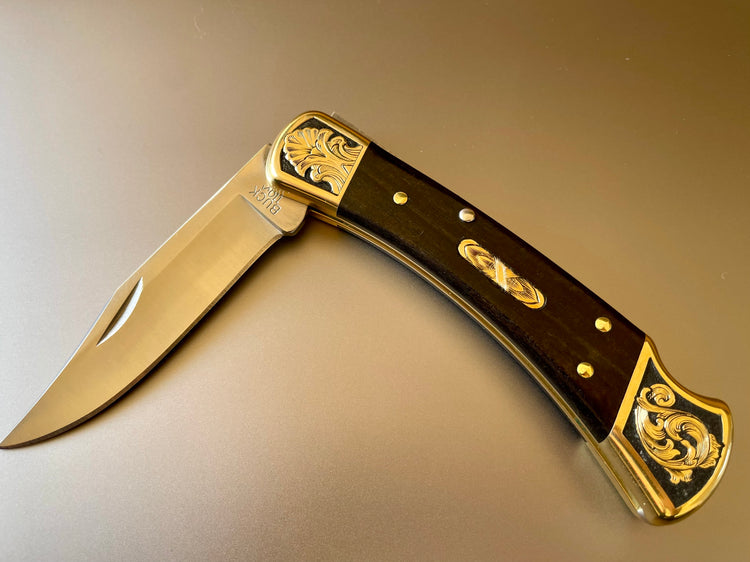 Hand engraved Buck 110 folding knife